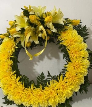 Yellow wreath with floral tie and lily