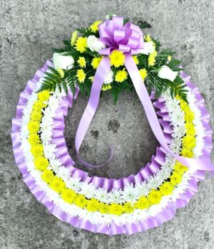 Wreath in yellow and white with pink ribbon