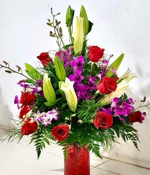 Lilies, Orchid sprays and Roses Arranged.